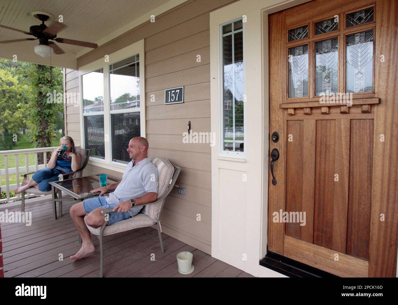 Tammy Schweigert, left, and Michael Schweigert sit on their front porch in the Borondo Pines
