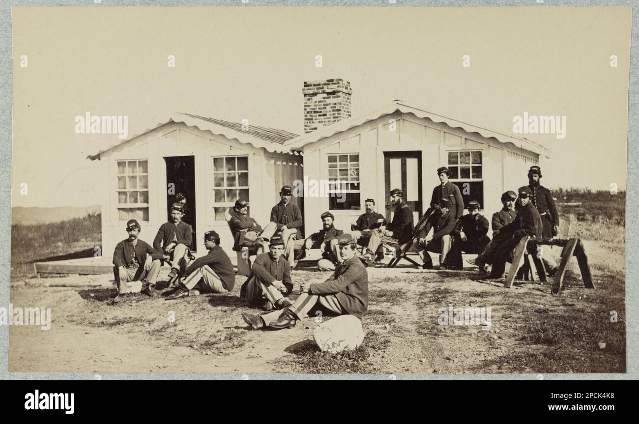 Group of soldiers outside winter quarters. No. 285, Title devised by library staff, Gift; Col. Godwin Ordway; 1948. United States, History, Civil War, 1861-1865. Stock Photo