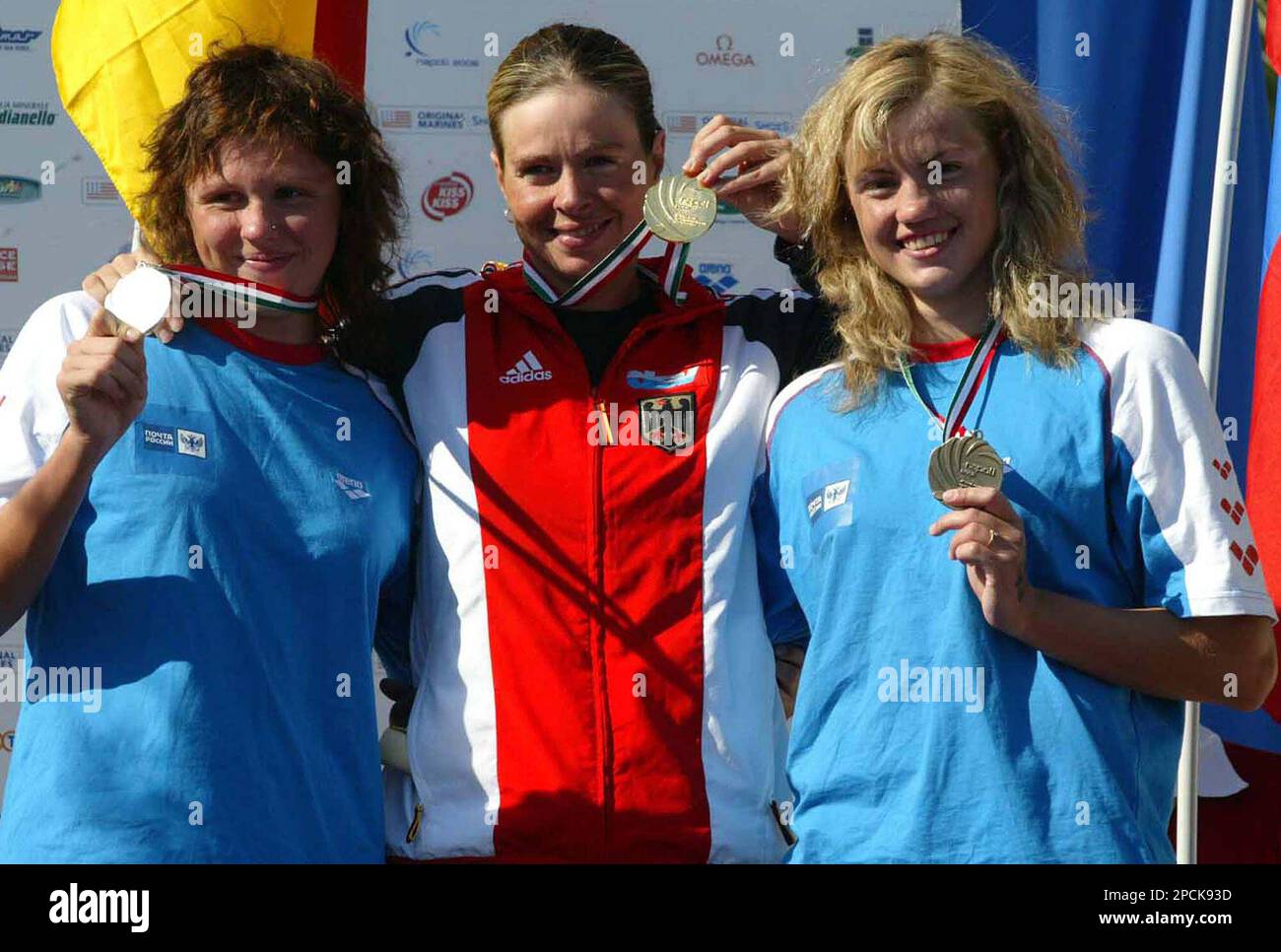 Germanys Angela Maurer, center winner of the 25km women race, shows her  gold medal flanked by second placed Natalia Pankina of Russia, left, and  third placed Ksenia Popova of Russia, at the