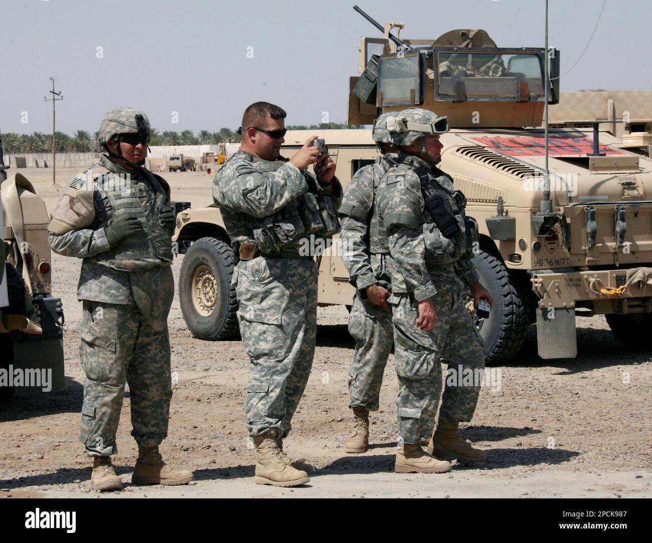 A U.S. soldier takes a photograph as others give a last look to the Abu ...