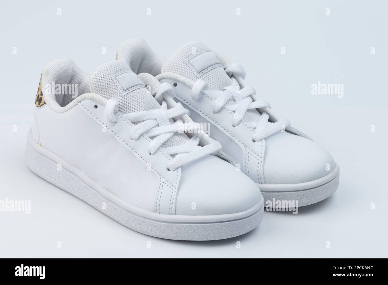 Child white pair of shoes with laces isolated perspective view Stock Photo