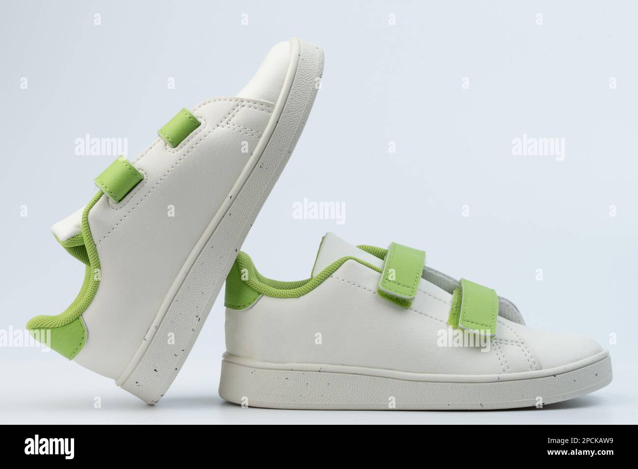 Classic white kids sneakers shoes with velcro side view isolated Stock Photo
