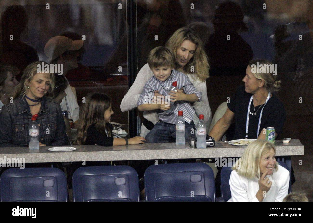 Former tenis pro, and wife of Andre Agassi, Steffi Graf watches Agassi's  match against Andrei Pavel of Romania with their children Jaden Gil, on  lap, and Jaz Elle, second from left, at