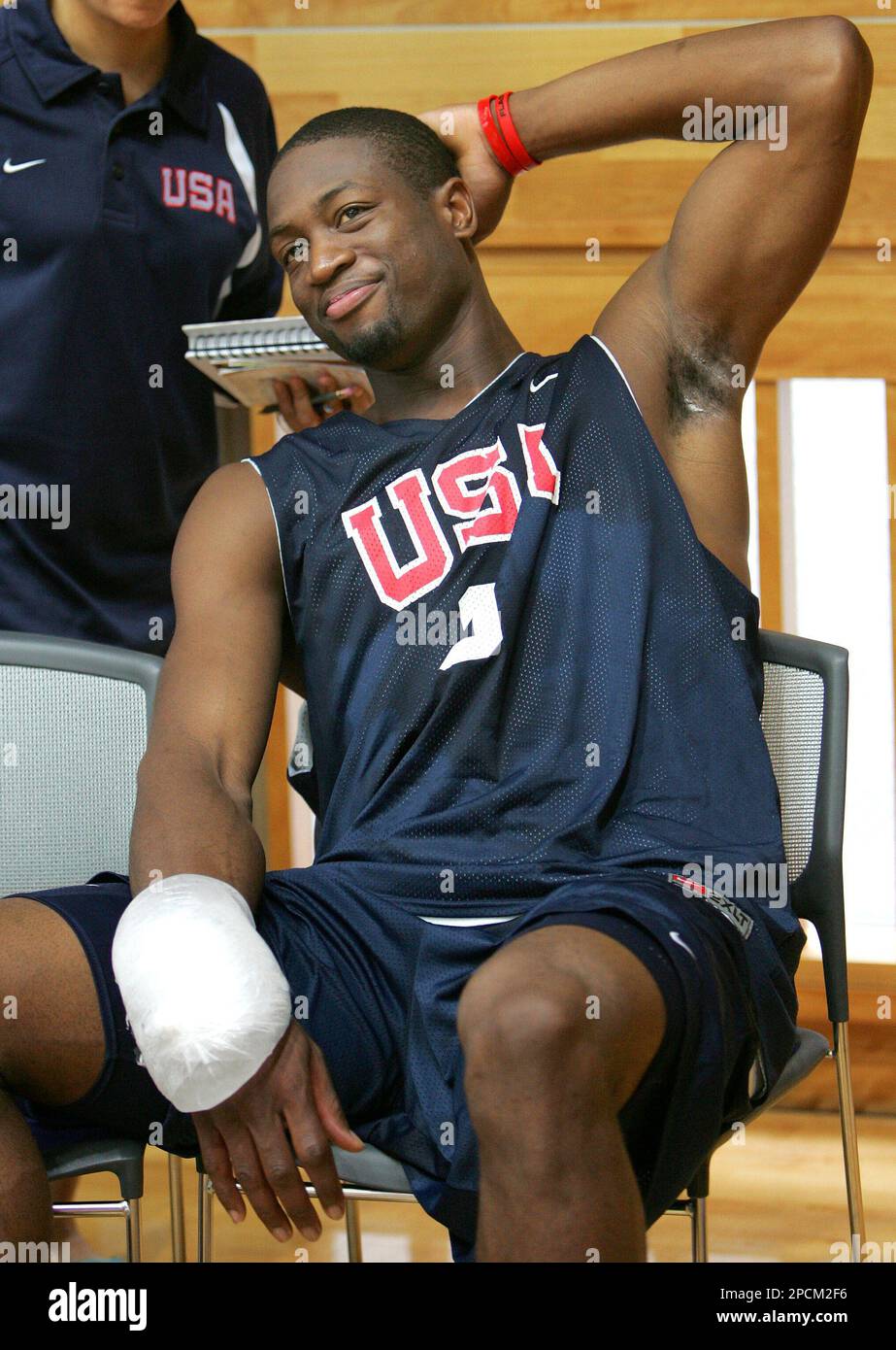 USA national team s Dwyane Wade cools his wrist with ice as he relaxes after the team s practice in Tokyo Saturday Aug. 26 2006. The American team prepares for the second round of
