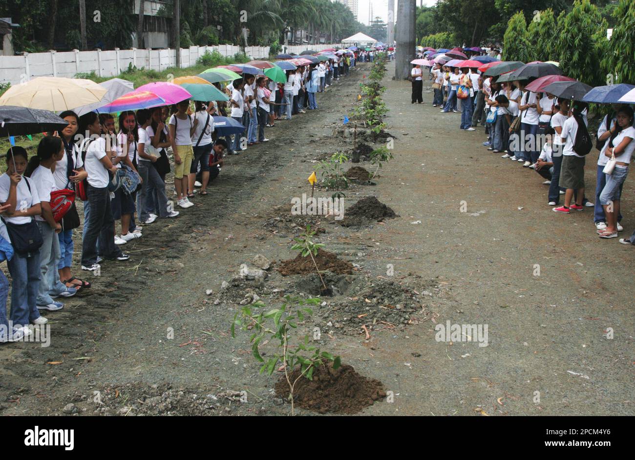 Students line up along the vacant stretch of the railroad tracks in