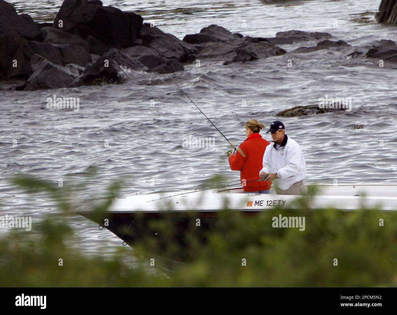 President Bush, right, fishes for stripers with his daughter, Jenna, off  the rocks near his father's summer home in Kennebunkport, Maine, on  Thursday, Aug. 24, 2006. The president went fishing on Fidelity, image size:1300x1030