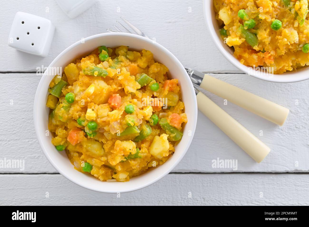 Charquican, a traditional Chilean dish, vegetarian version, made of lightly mashed and mixed potatoes, pumpkin, onion, carrots, peas, corn and beans Stock Photo
