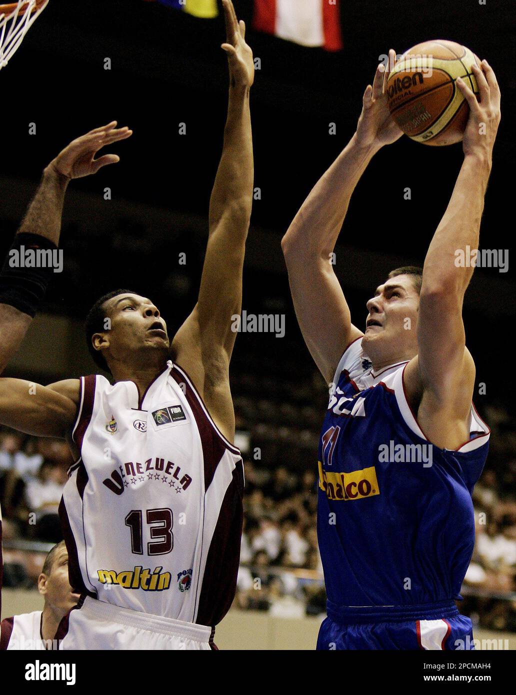 Serbia and Montenegro's Darko Milicic, right, of the NBA Detroit Pistons,  challenges for the ball with Latvia's players during their preliminary  round basketball match, at European Championship for Men, Eurobasket 2005,  in