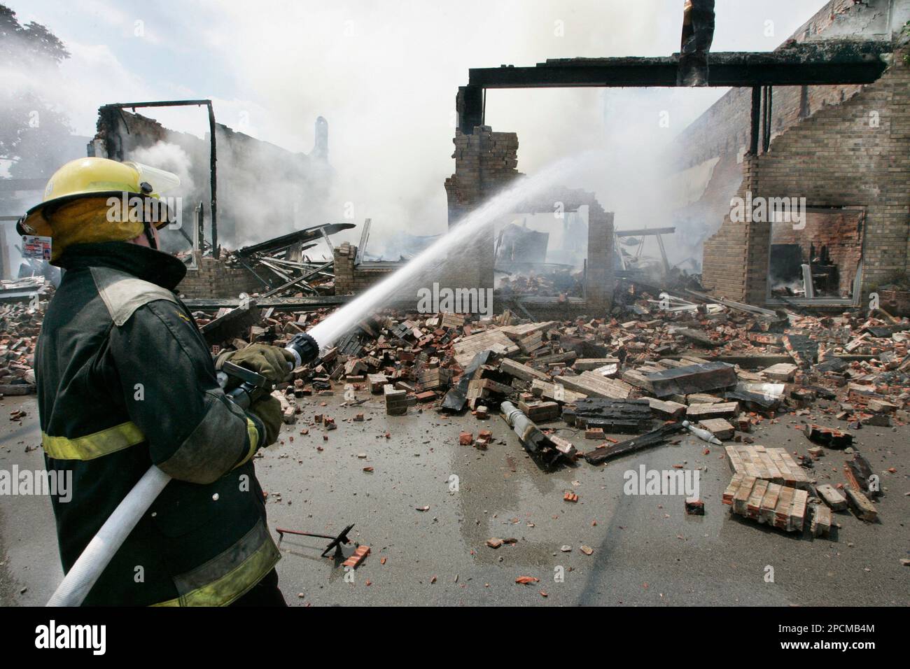 Firefighters from three volunteer departments use suppressant foam to  extinguish a fire in a salt water storage tank at a natural gas well near  Nacogdoches, Texas, on Tuesday, Dec. 4, 2012. Katie