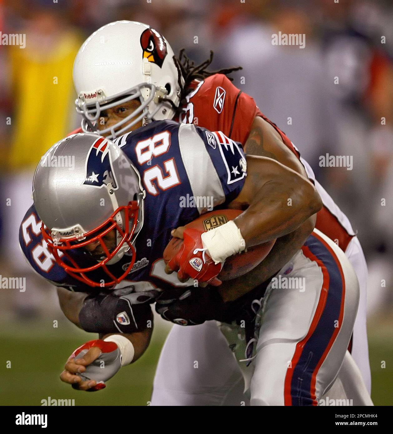 New England Patriots running back Corey Dillon (28) is brought