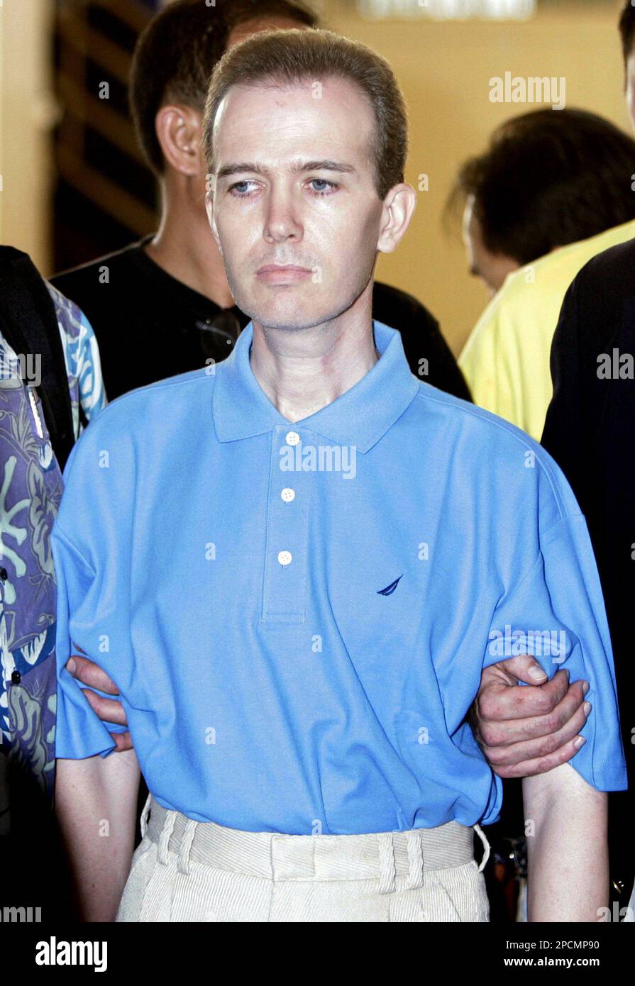 Murder suspect John Mark Karr is led by Thai and U.S. officials from