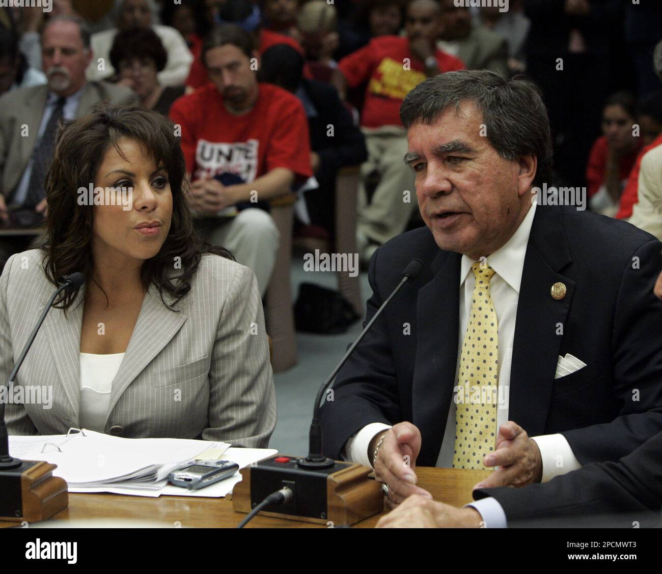 Richard Milanovich, tribal chairman of the Agua Caliente Band of Cahuilla Indians, answers a question concerning the gaming agreement reached with California Gov. Arnold Schwarzenegger, during a hearing of the Senate Government Organization Committee at the Capitol in Sacramento, Calif., Wednesday, Aug. 16, 2006. If approved by the Legislature, the measure, sponsored by Assemblywoman Bonnie Garcia, R-Cathedral City, left, would allow the Agua Calientes to increase the amount of slot machines in their casinos as well as adding a third Palm Springs-area casino in exchange for sending nearly $2 b Stock Photo