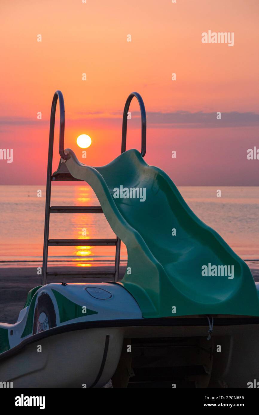 pedal boat on the beach during amazing ocean sunrise Stock Photo Alamy