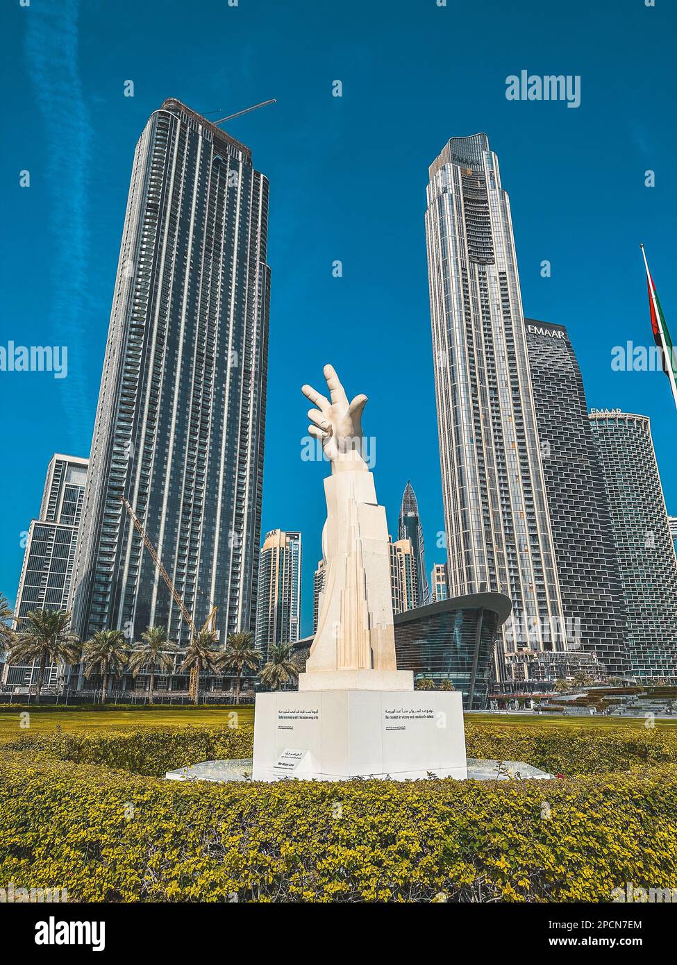 Three Fingers Statue in Burj Park surrounded by skyscrapers in Downtown