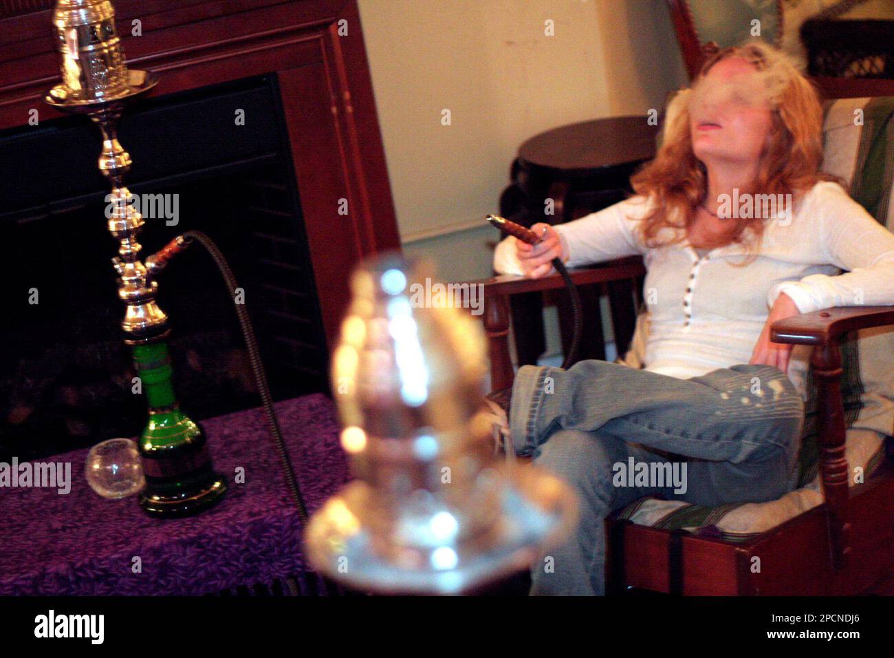 Audrey Meyer smokes from a hookah at the Purple Caterpillar in Portland