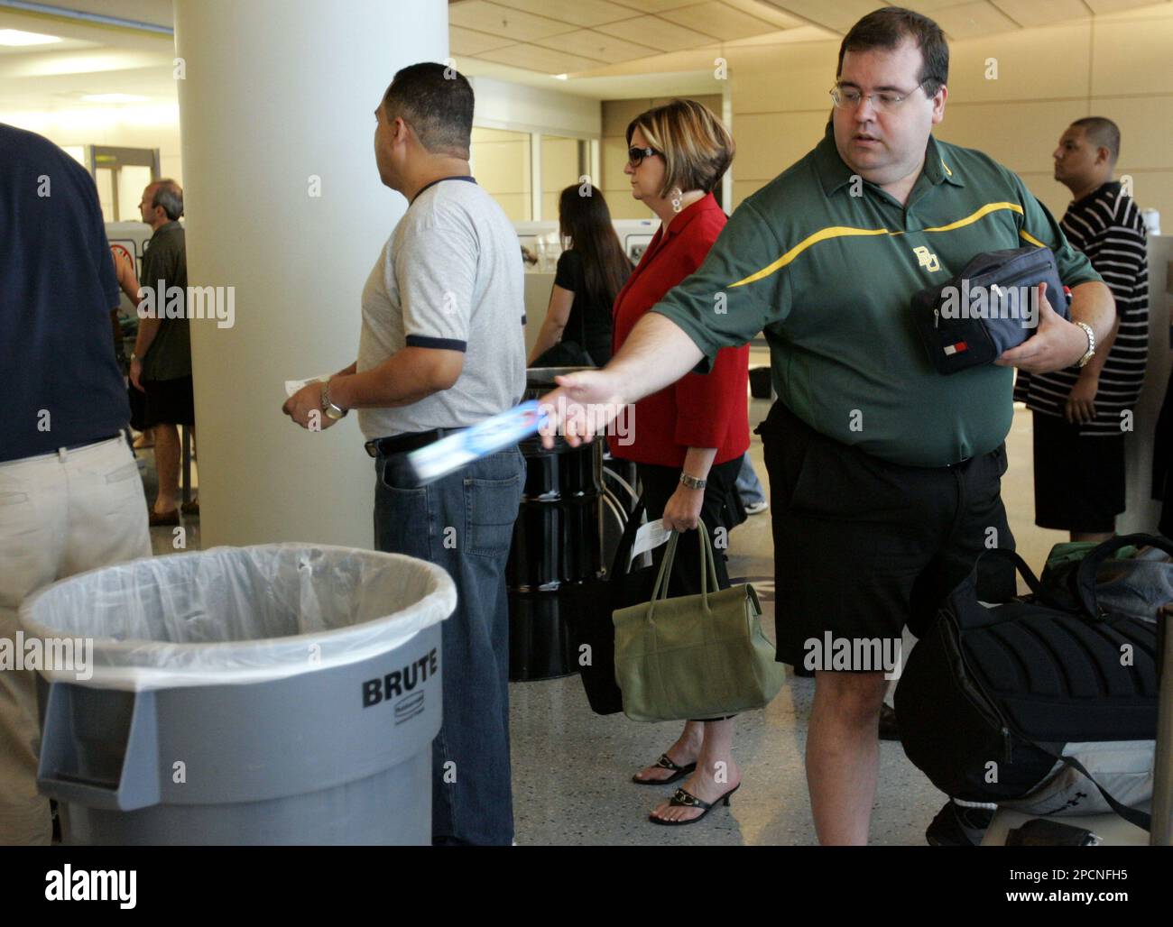 Greg Schiller throws away toothpaste from a carry-on bag as he prepares to  travel from the Dallas-Fort Worth Airport in Grapevine, Texas, Thursday,  Aug. 10, 2006. In response to a thwarted terror