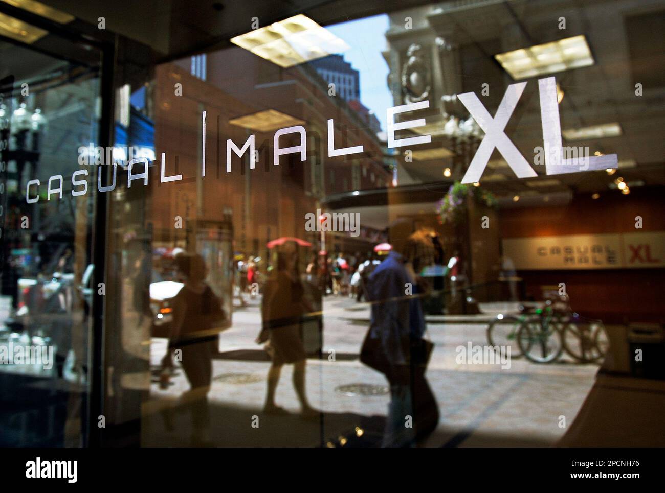 Casual Male XL s glass door reflects passersby at Boston s