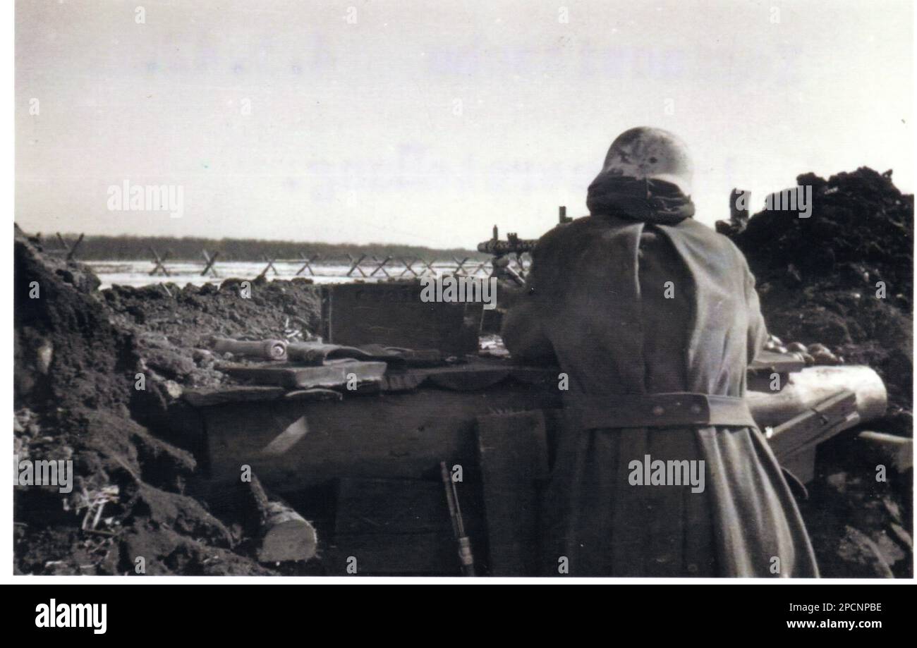 World War Two B&W photo German Soldier in a defensive position with a light MG34 on the Leningrad Front 1942 Stock Photo