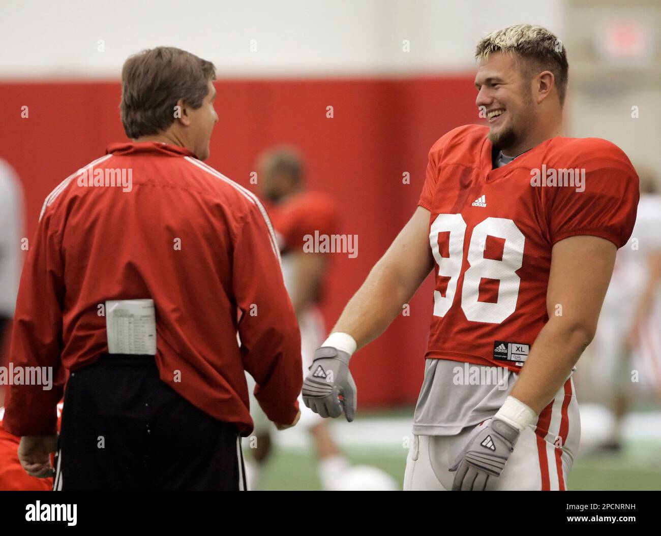 Nebraska football coach Bill Callahan jokes with defensive end Zach
