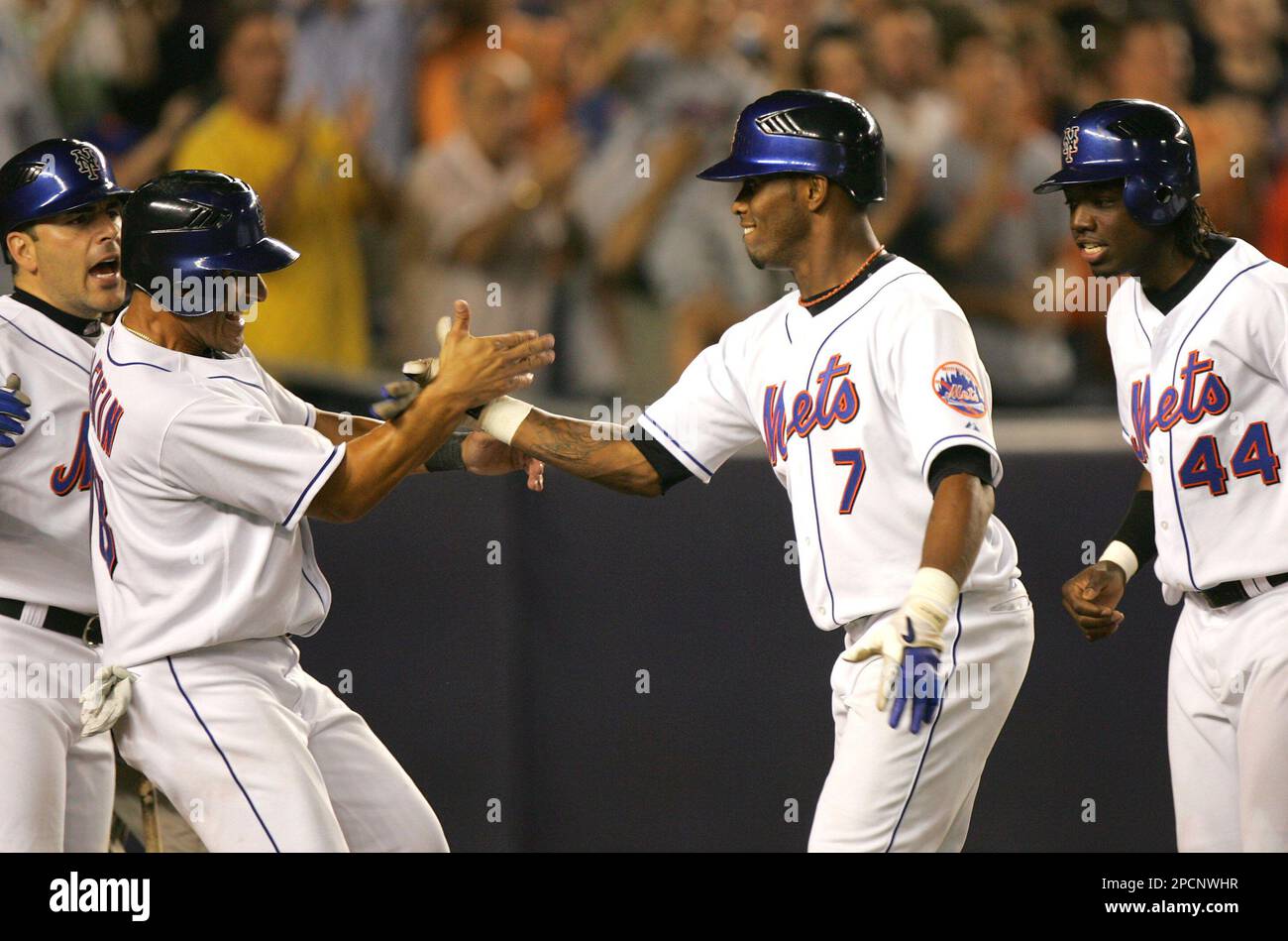 New York Mets' Jose Reyes is congratulated by David Wright, left, Jose  Valentin, second left and Lastings Milledge after hitting a grand slam  against the Philadelphia Phillies during the fourth inning of
