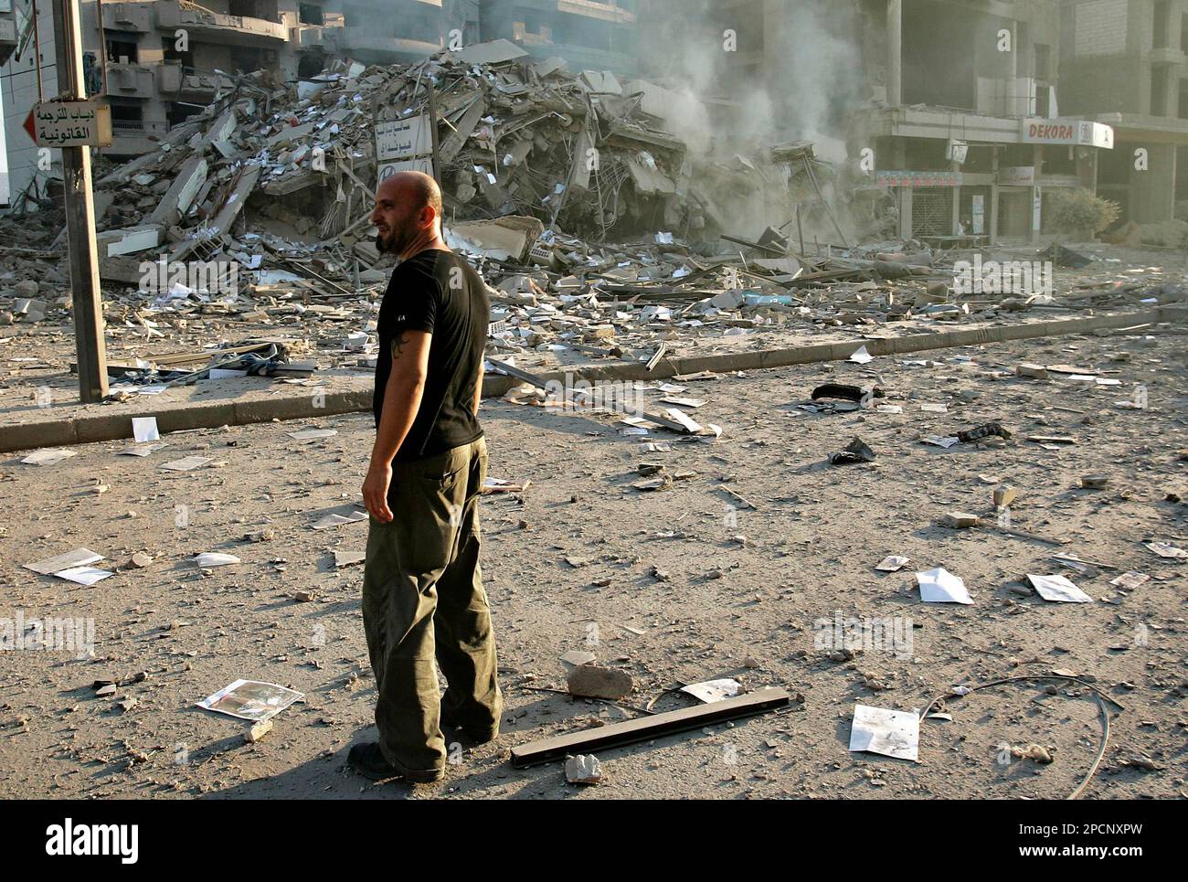 A Lebanese man inspects the scene where Israeli jets fired missiles in ...