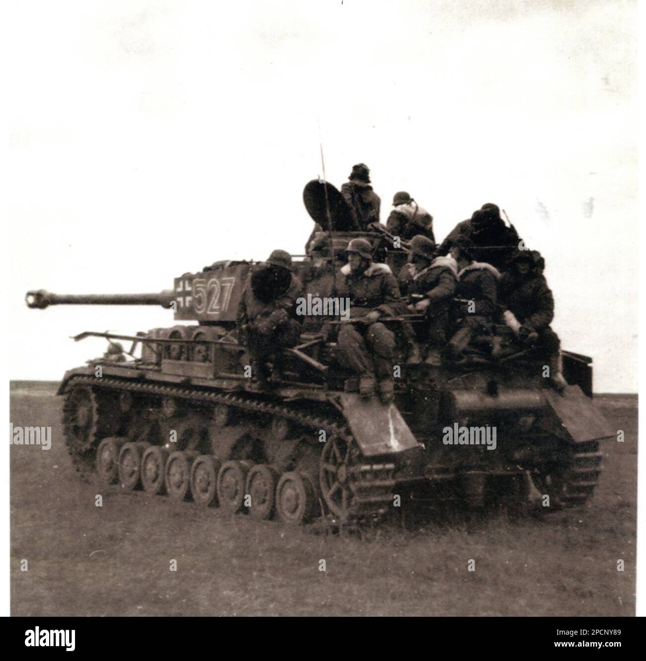 World War Two B&W photo  German Soldiers ride on a Panzer lV on the Russian Front 1944.  The Tank and troops are from a Waffen SS unit Stock Photo