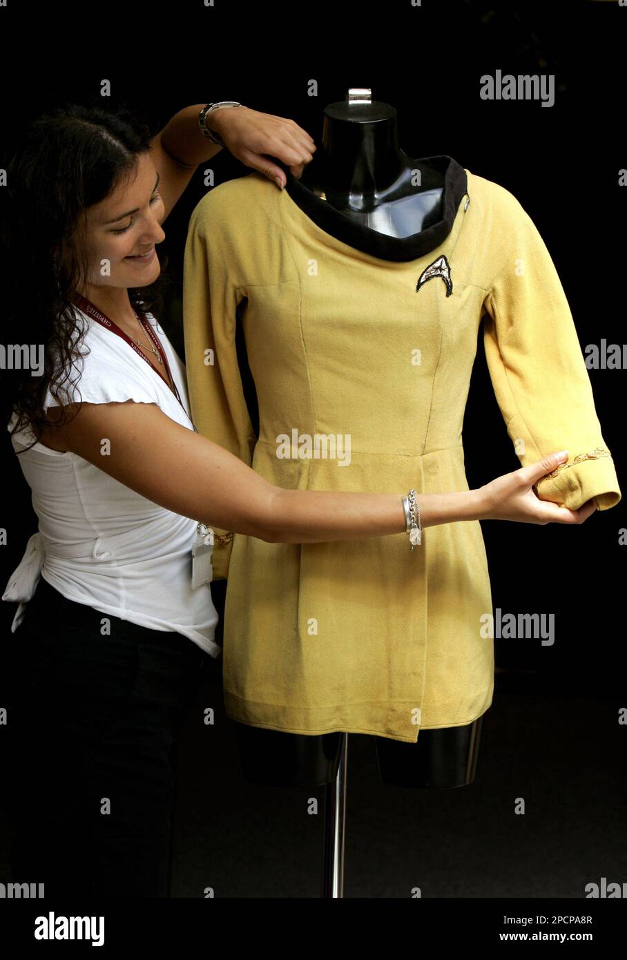 Zoe Schoon from Christie's auction rooms, London, arranges a  mustard-coloured Starfleet mini-dress uniform worn in the original Star Trek  television series and estimated at $4,000-6,000, Wednesday Aug. 2, 2006.  The dress is