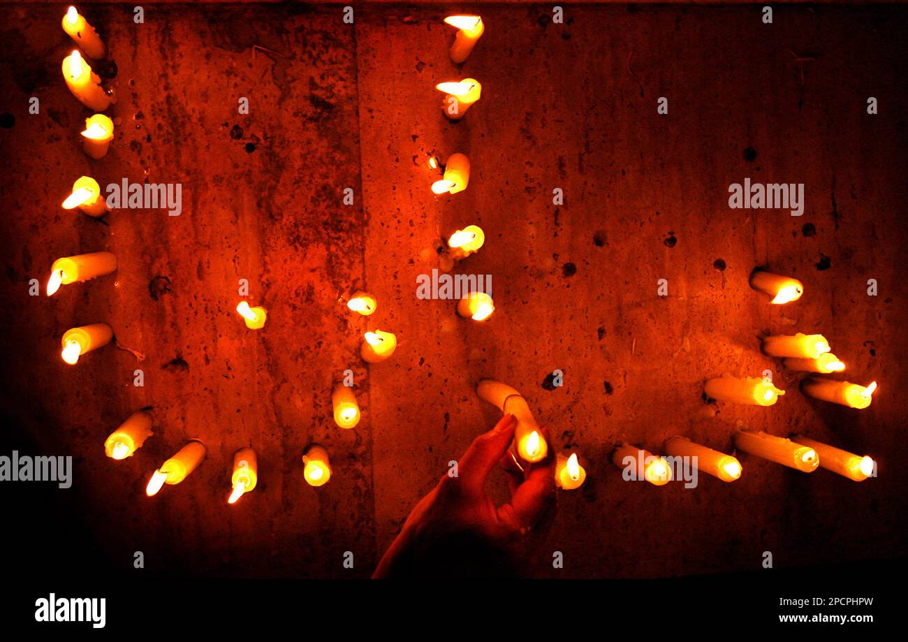 A Lebanese woman places candles to form the word 