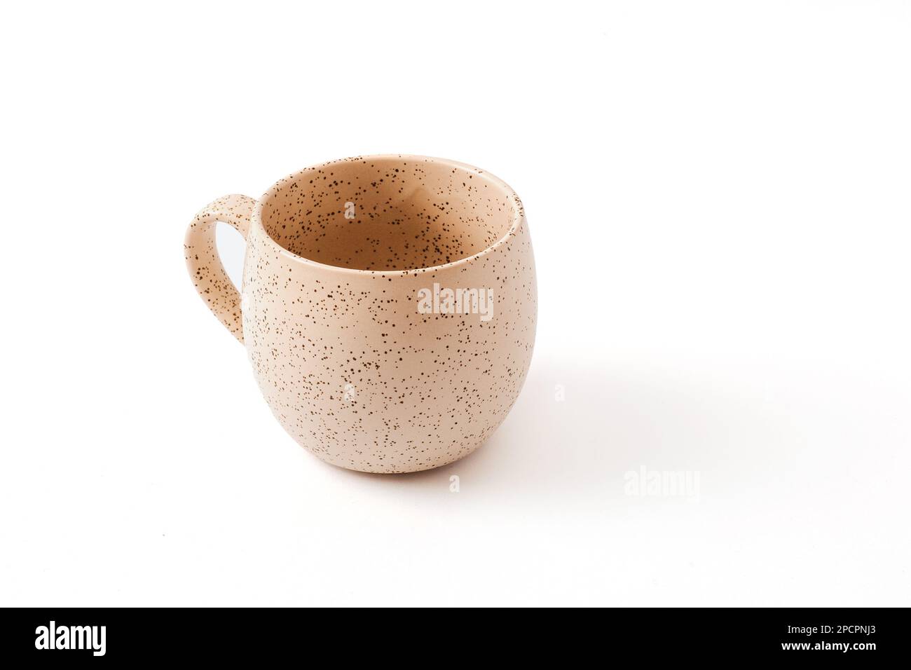 Empty beige coffee ceramic cup on isolated white background, cut out. View from above. Stock Photo