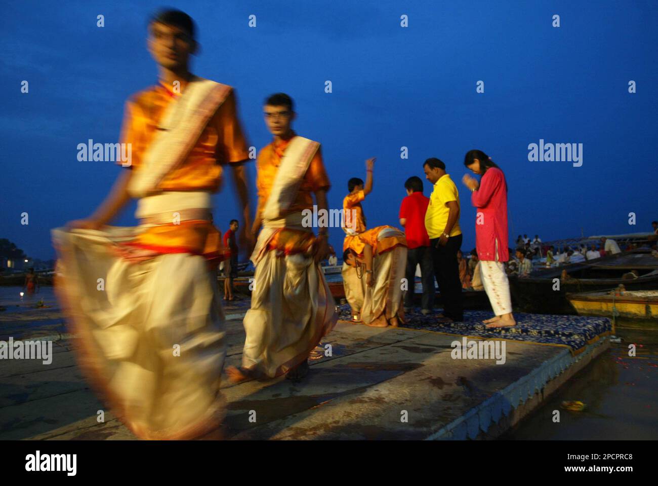 Hindu devotees pray at dusk on the banks of the River Ganges in