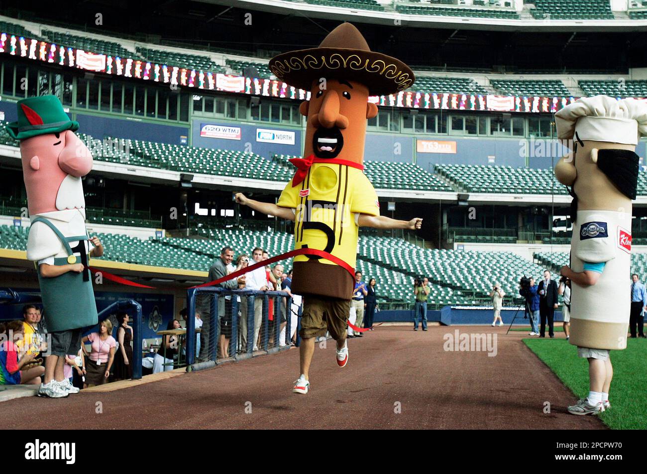 The Milwaukee Brewers' newest racing sausage Chorizo, center, crosses