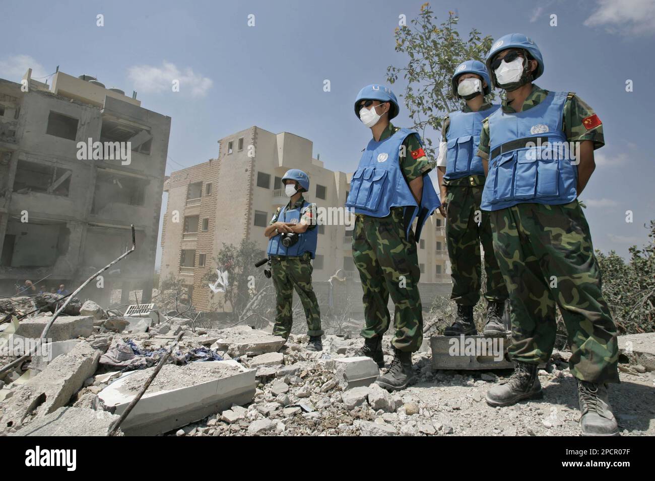 United Nations soldiers from China watch at the rubble of a destroyed ...