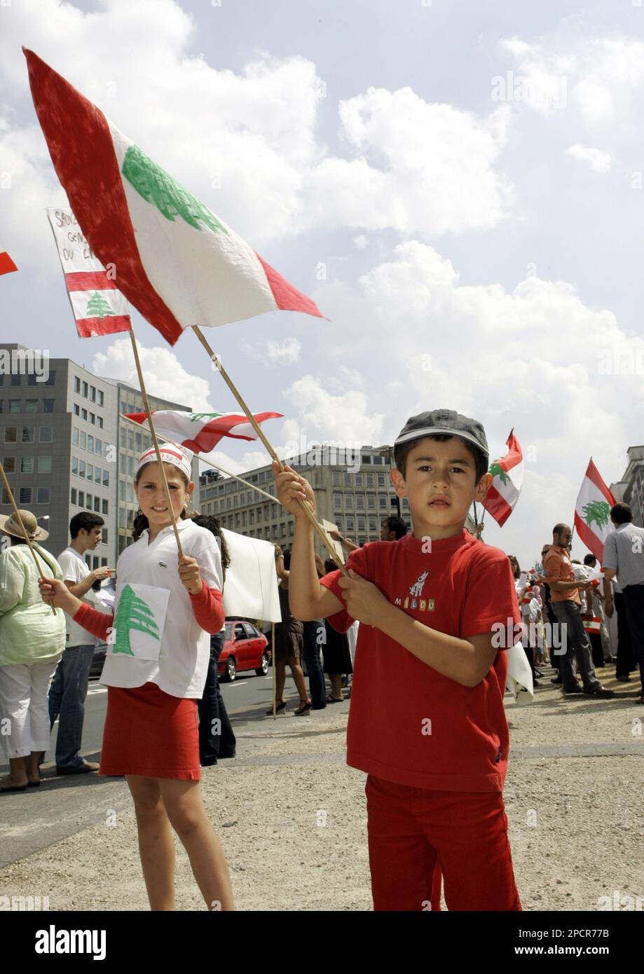 Children wave Lebanese flag as they protest outside the European Council  headquarters in Brussels against the recent developments in Lebanon,  Monday, 24 July, 2006. EU foreign policy chief Javier Solana met with