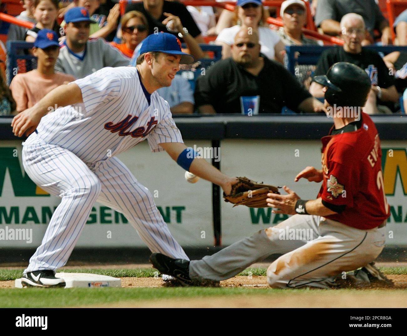 The ball sails past the outstretched glove of New York Mets third baseman David  Wright as Houston Astros Adam Everett, right, slides safely in after  stealing second and taking third on an