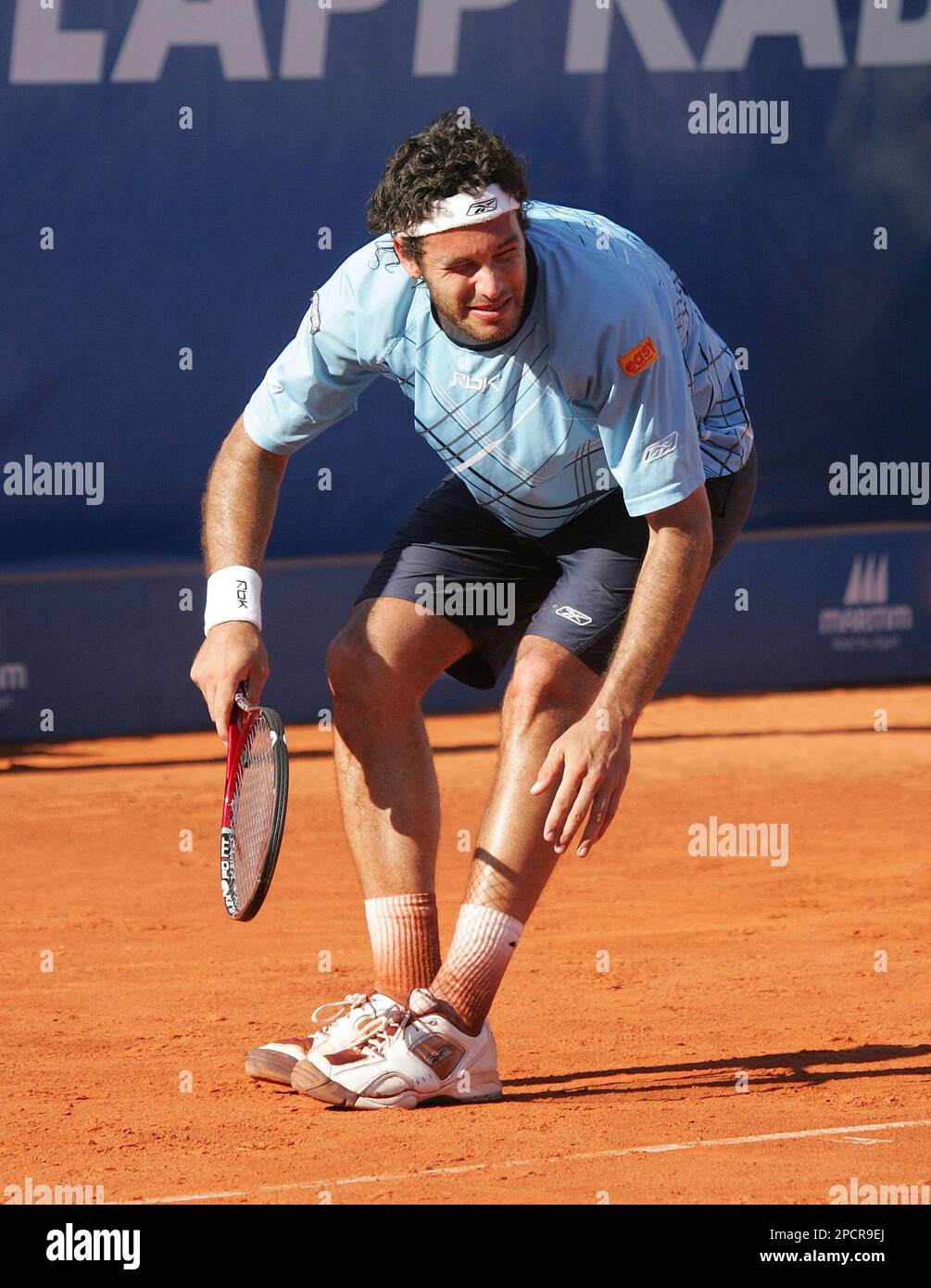 Jose Acasuso from Argentina falls as he suffers a dizzy spell during