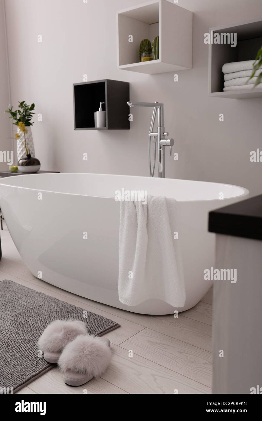 Stylish bathroom interior with modern white tub Stock Photo - Alamy