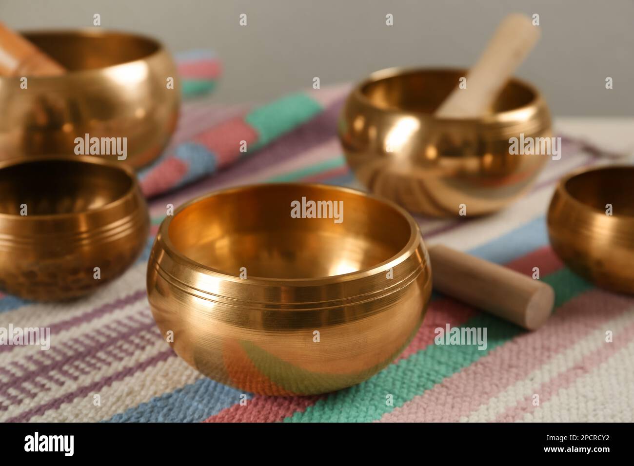 Tibetan singing bowls with mallets on colorful fabric Stock Photo Alamy