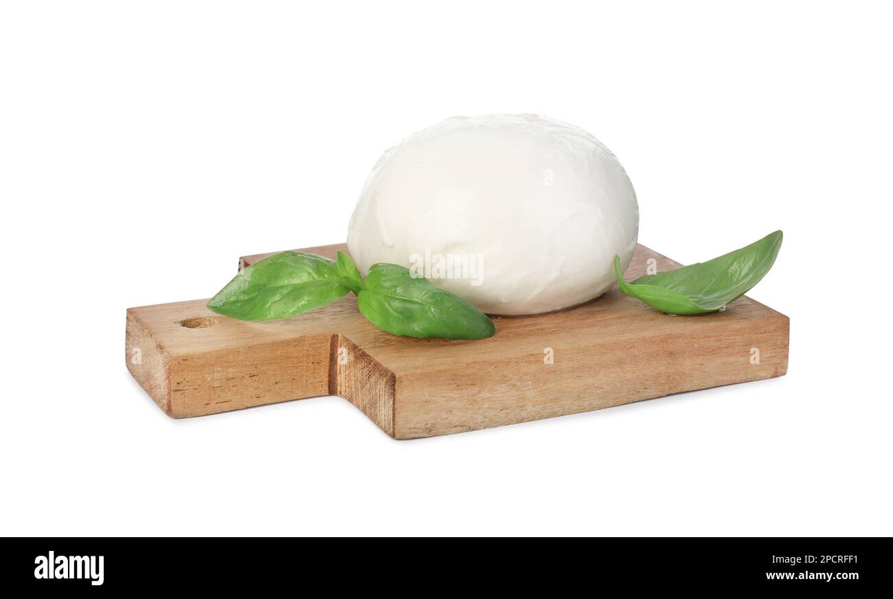 Wooden board with delicious mozzarella cheese ball and basil on white background Stock Photo