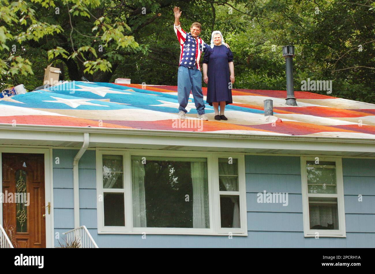 Homeowners Alexa and Elena Popa wave from their rooftop after New York ...