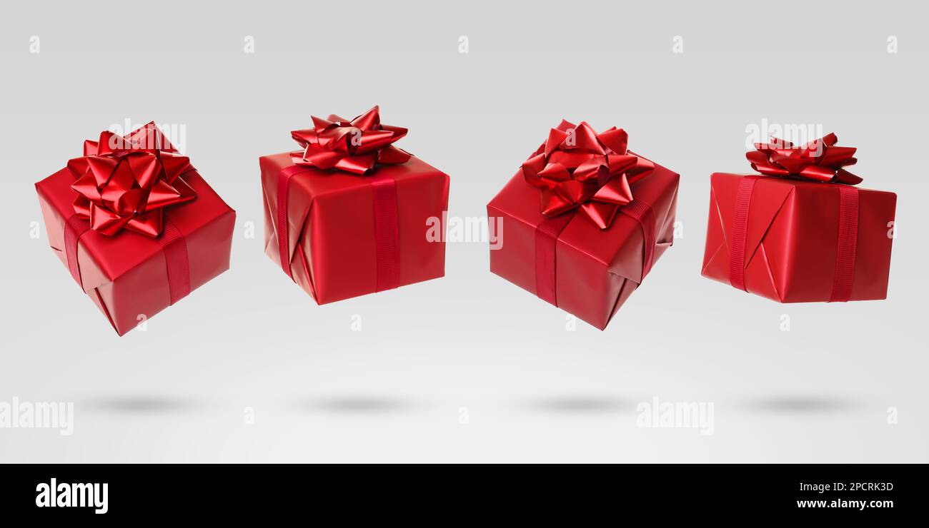 Beautifully wrapped gift boxes flying on light background Stock Photo