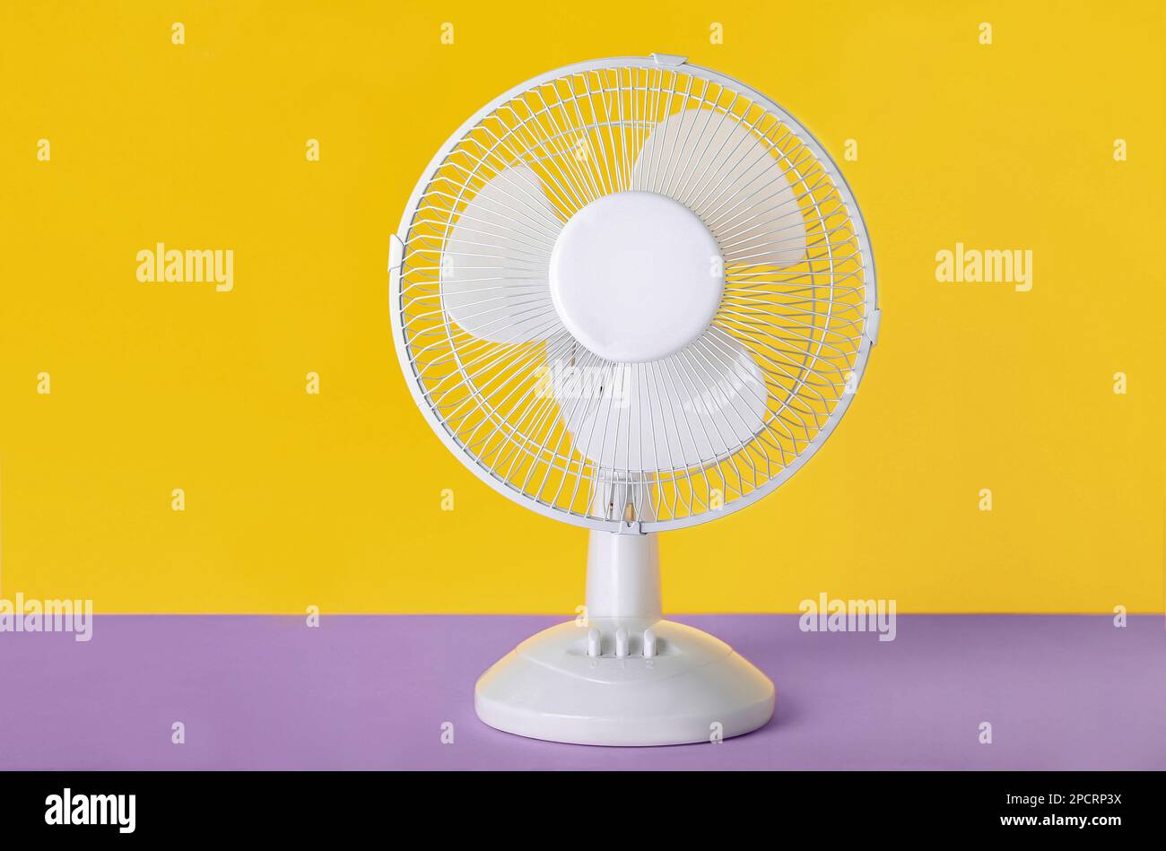 Electric fan on yellow background Stock Photo