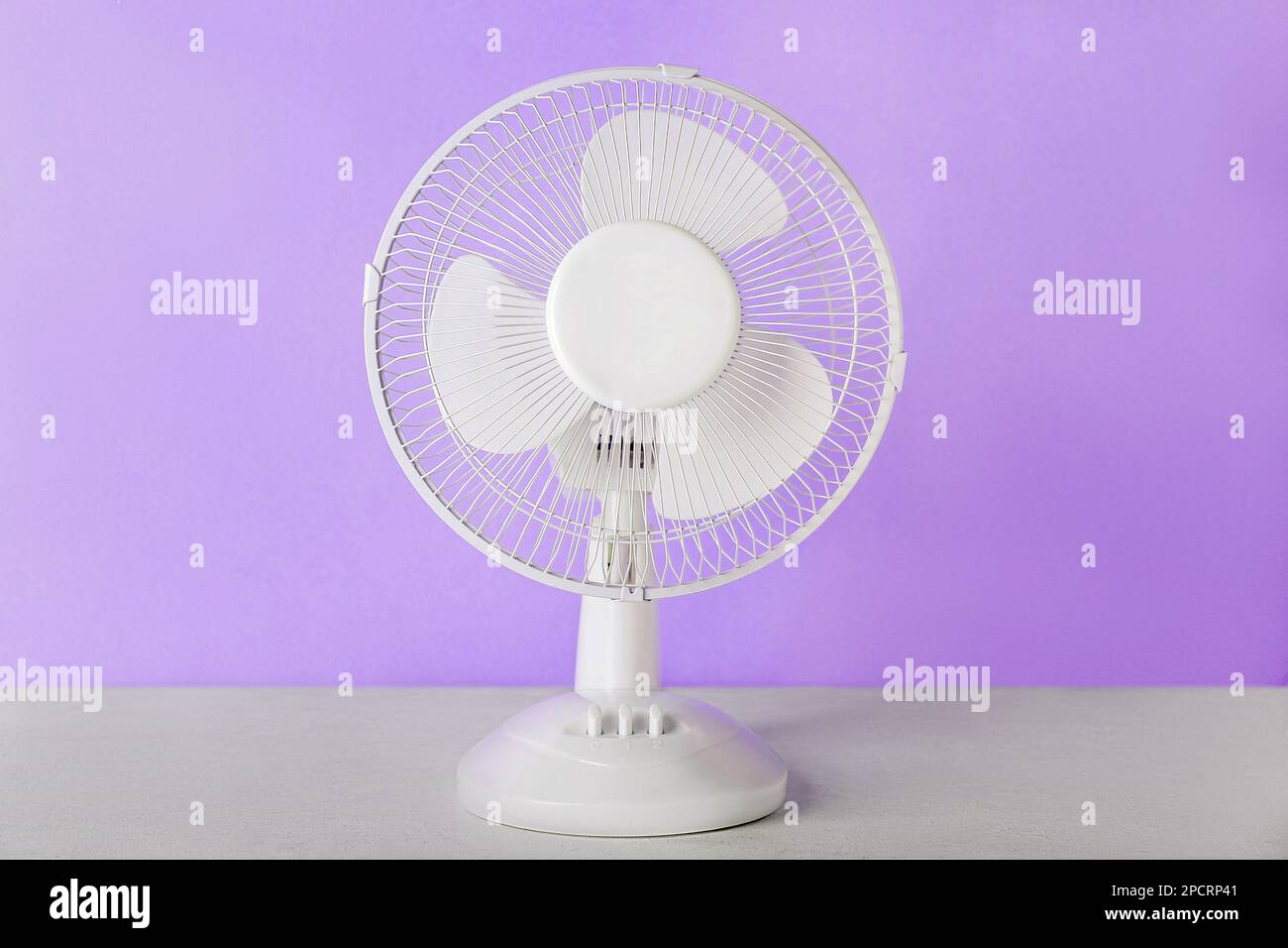 Electric fan on lilac background Stock Photo