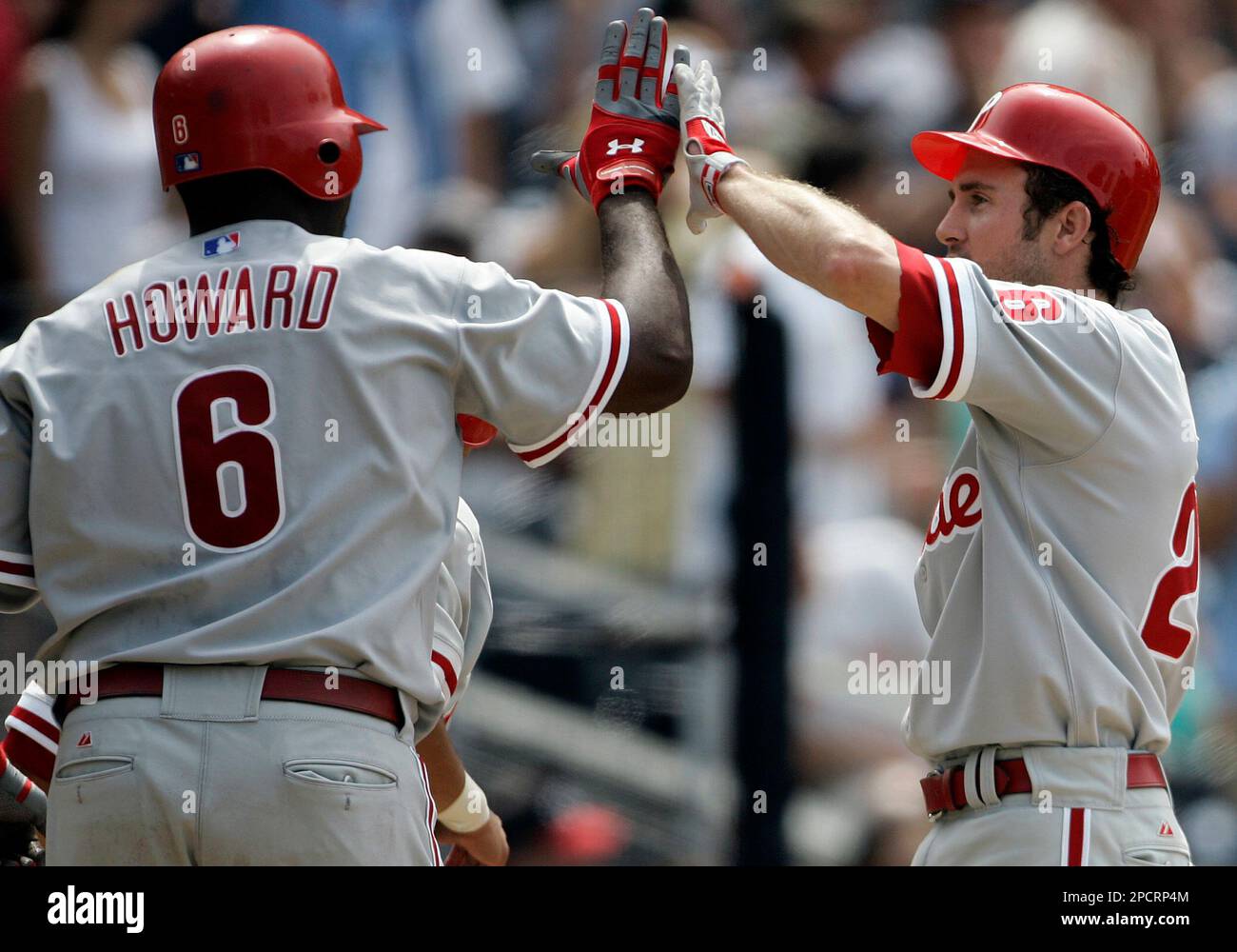 Philadelphia Phillies' Chase Utley, right, is congratulated by Ryan Howard  after scoring the go-ahead run against the San Diego Padres in the ninth  inning of a baseball game Wednesday, July 19, 2006