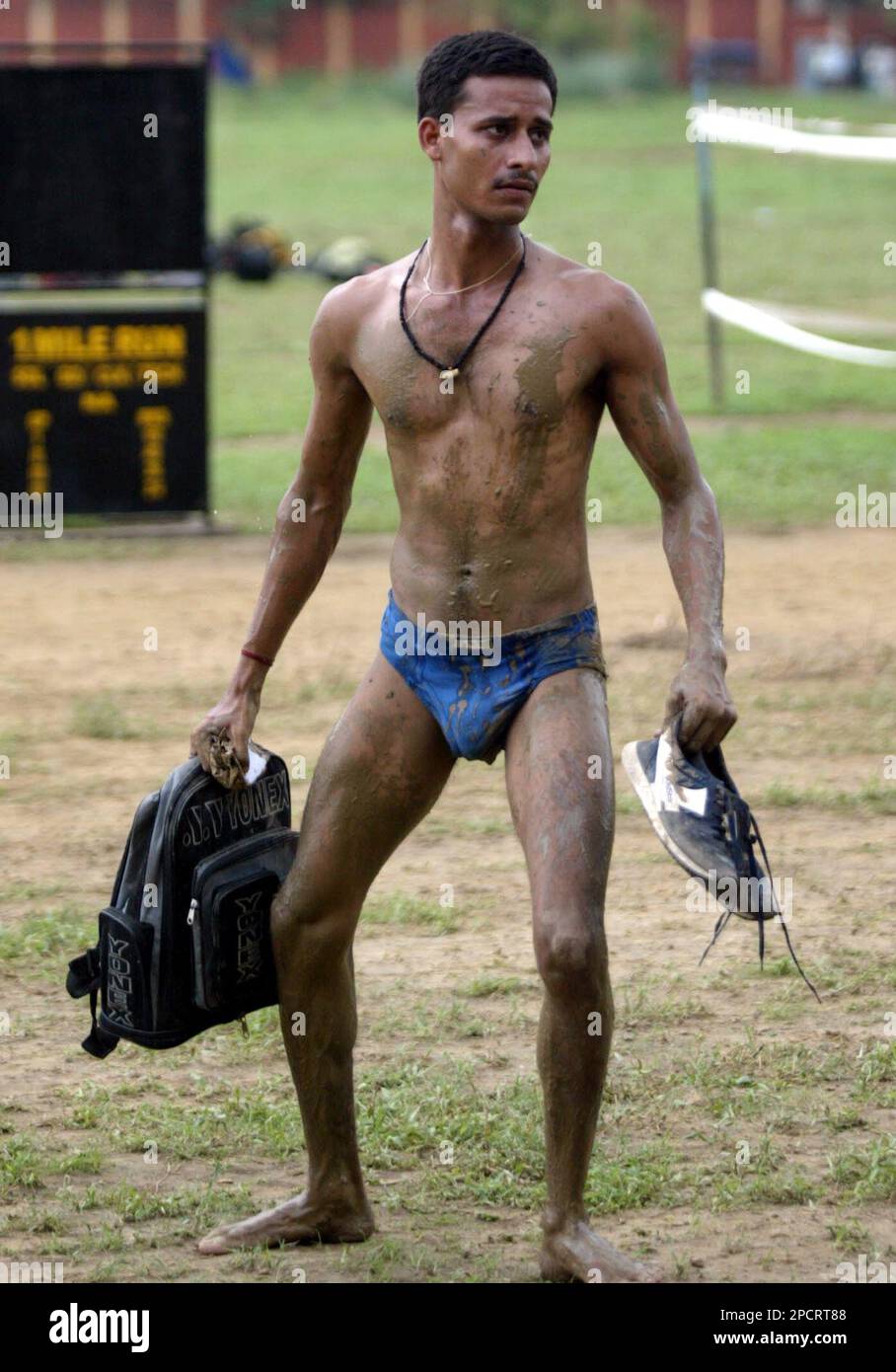 A prospective army candidate carries his belongings after