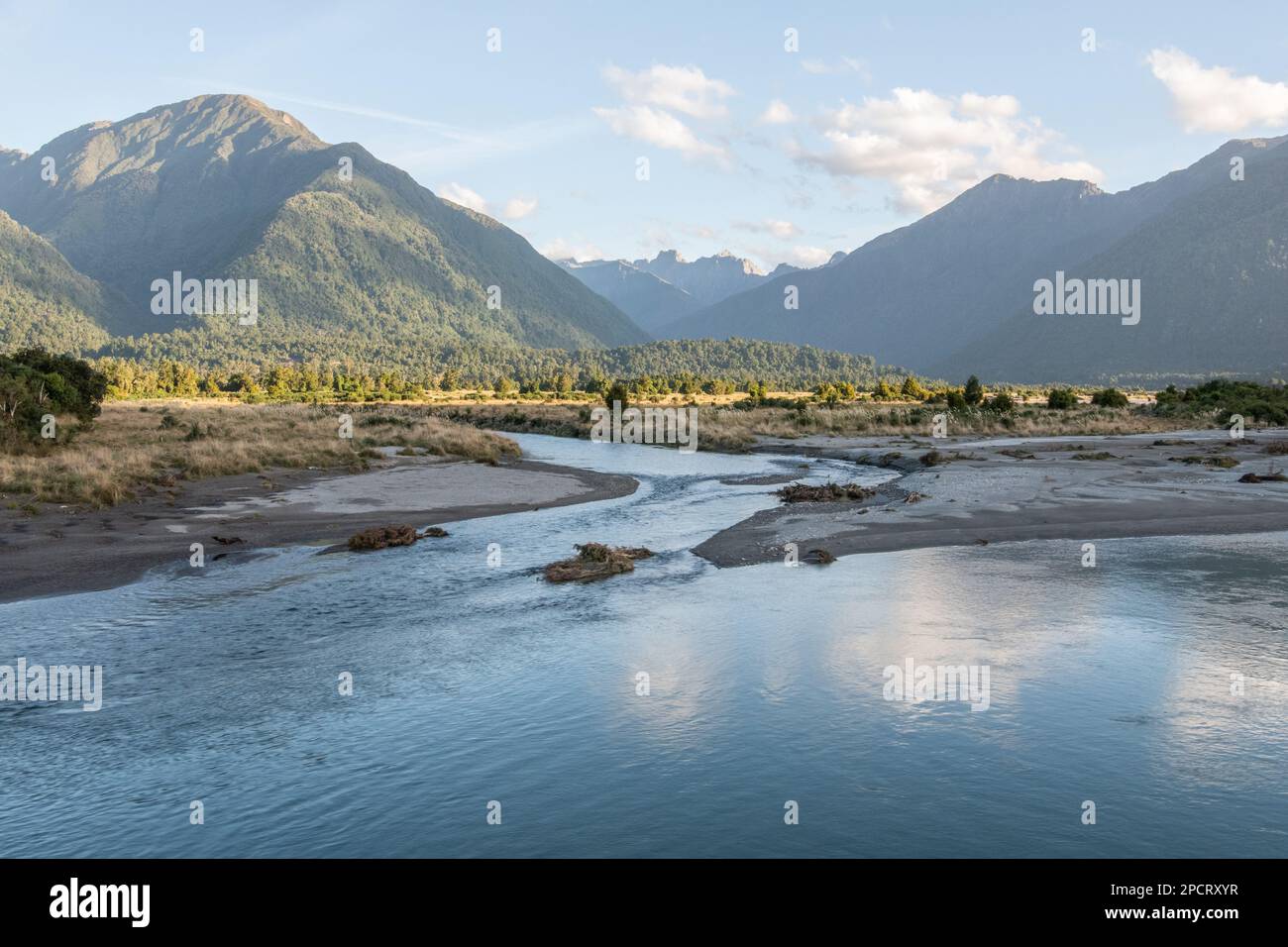 Mahitahi River flowing across the landscape from the Southern Alps in the South island of Aotearoa New Zealand. Stock Photo