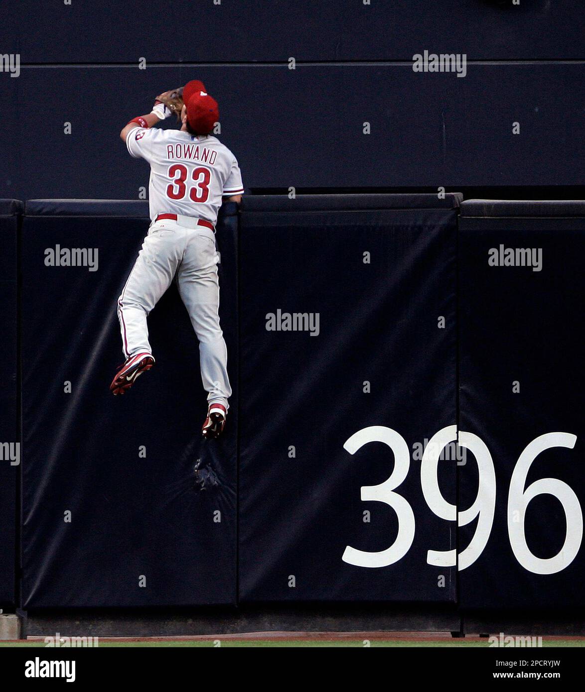 Philadelphia Phillies center fielder Aaron Rowand climbs he fence but  cannot reach a solo homer by San Diego Padres' MIke Cameron in the first  inning of their baseball game Monday, July 17