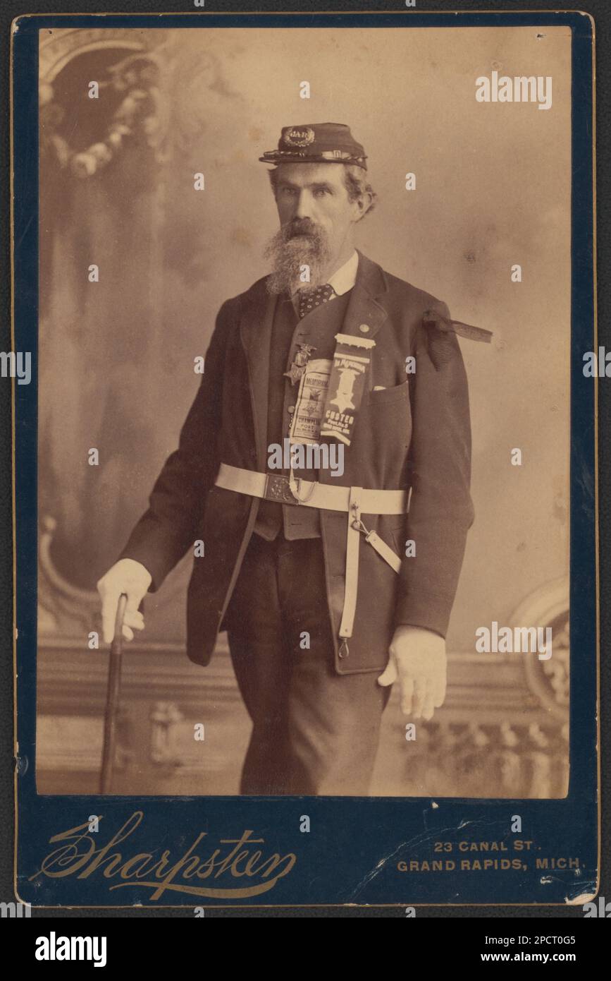 Civil War veteran with G.A.R. insignia on cap, wearing memoriam ribbons ...