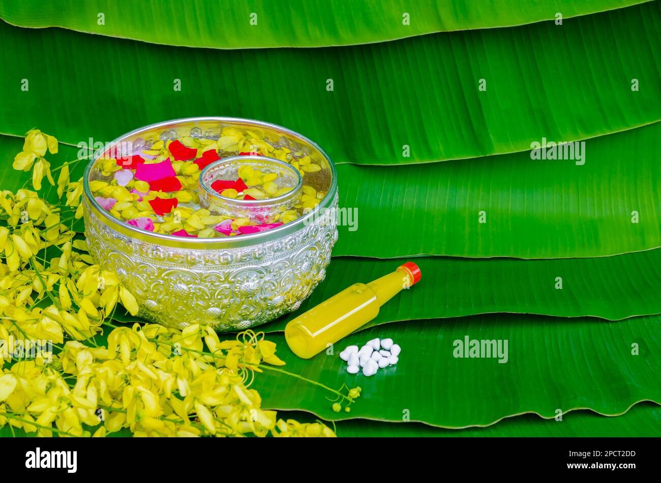 Songkran festival background with flowers in water bowls, scented water