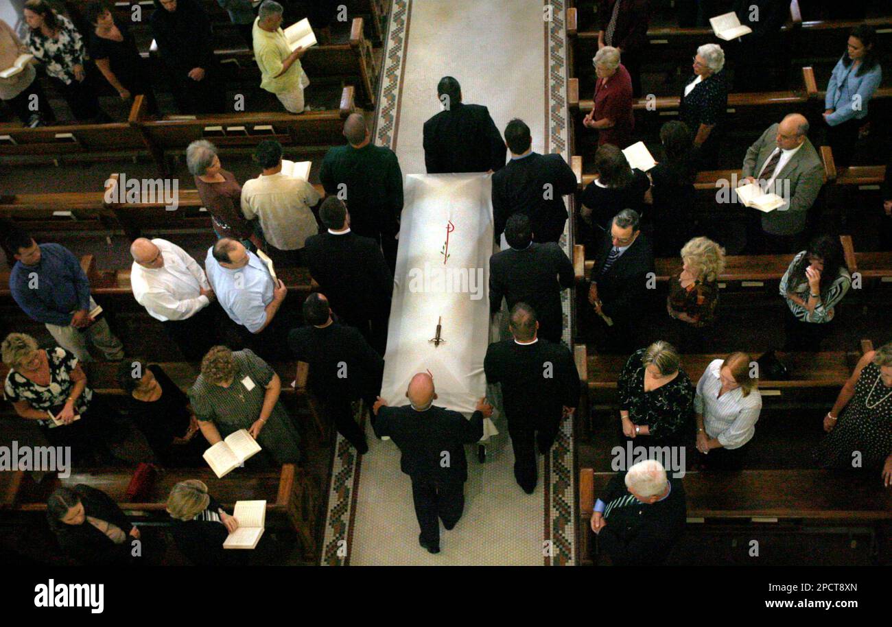 Civilian pallbearers bring the casket of Army Cpl. Aaron Griner into