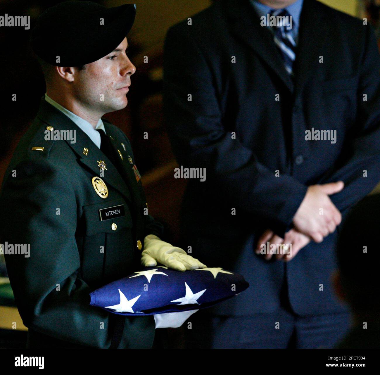 National Guard Honors Team member 2nd Lt. Sean Kitchen carries a folded